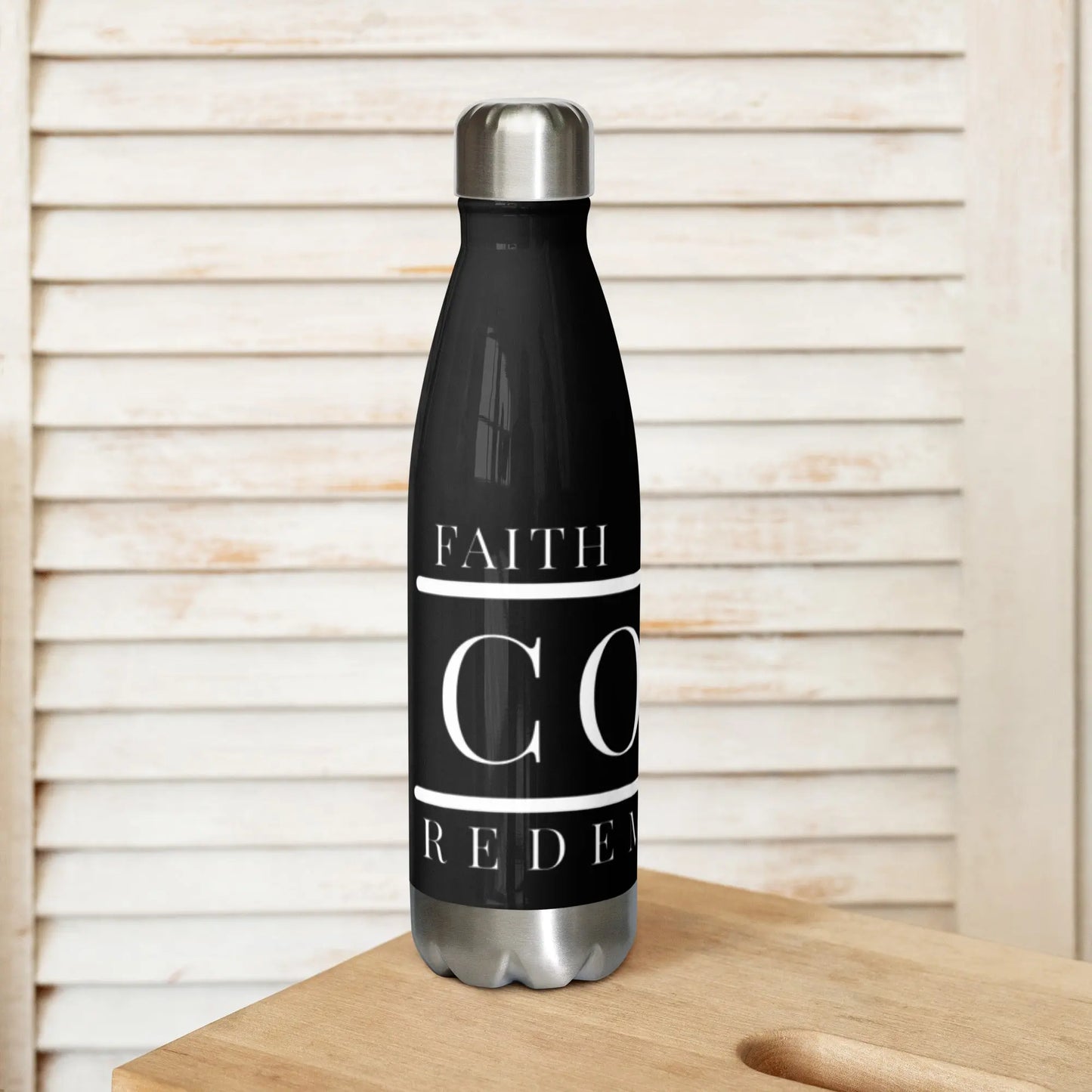 COTK Christian faith stainless steel water bottle 17 oz in black with American flag draped over the cross, with the words faith, honor, redemption.